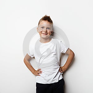 Young little boy wearing white tshirt and smiling