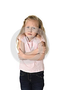 Young little child girl having cold gesturing and trembling isolated on white background