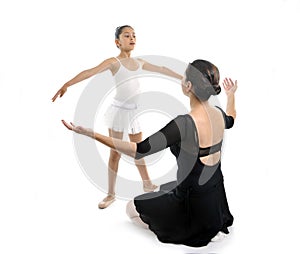 Young little girl ballerina learning dance lesson with ballet teacher