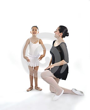 Young little girl ballerina learning dance lesson with ballet teacher