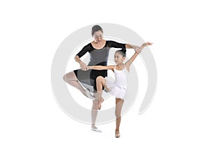 Young little girl ballerina learning dance lesson with ballet teacher