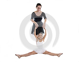 Young little girl ballerina learning dance lesson with ballet teacher