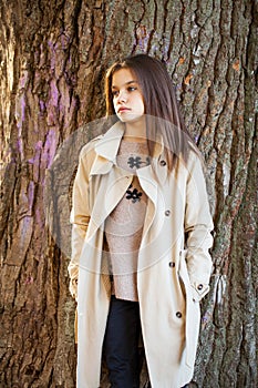 young little girl in beige coat