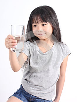 Young little girl drinking water.