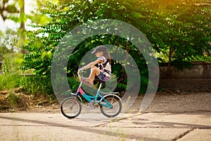 Young little girl learning to ride bike in park