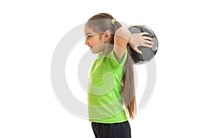 Young little girl plays with soccer ball