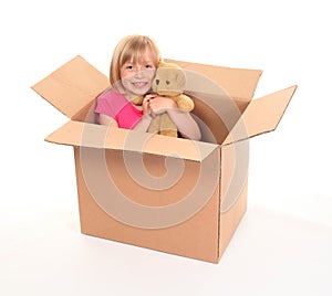 Young little girl sitting inside box