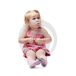 Young little girl sitting over isolated white background