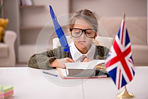 Young little girl studying english language at home