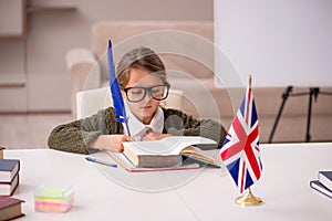 Young little girl studying english language at home