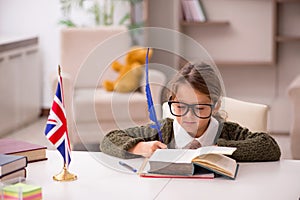 Young little girl studying english language at home