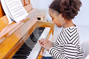 Young little student, practicing piano