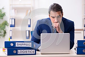 Young male logistics specialist working in the office