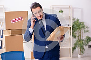 Young male logistics specialist working in the office