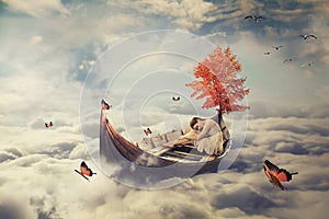 Young lonely beautiful woman drifting on a boat above clouds. Dreamy screensaver