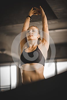 Young long blond woman attractive fitness exercise workout in gym. Woman stretching the muscles and relaxing after exercise