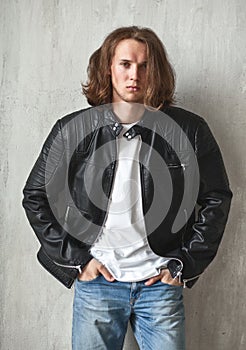 Young long-haired hunk with bristle in imposingly pose