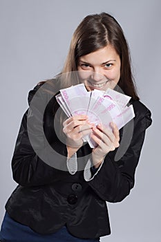 Young long-haired woman holding money