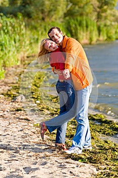 Young love Couple embrace on coast of river