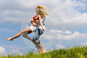 Young love couple having fun on spring meadow