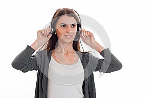 Young lovely business woman in uniform with headphones and microphone looking away and smiling isolated on white