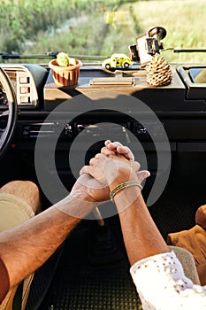 young lovely couple holding hands together, travelling on old retro vintage van