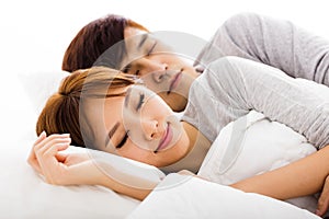 young lovely couple lying in a bed