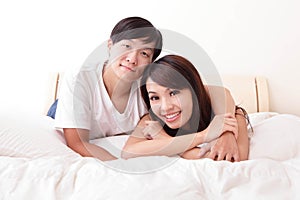 Young lovely couple lying in a bed