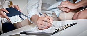 Young lovely couple are signing contract for a vacation. Close-up