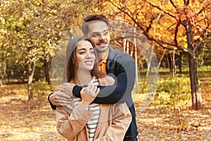 Young lovely couple spending time together in park