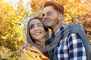 Young lovely couple spending time together in park