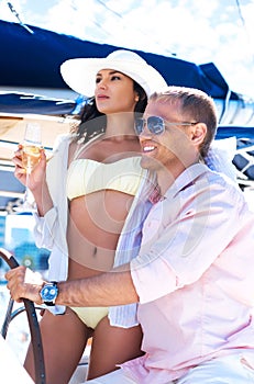 Young and lovely couple on a vacation on a boat