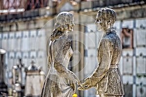 Young lovers while smiling marble statue