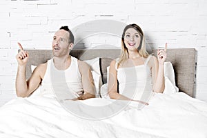 Young loving couple in the bed having idea