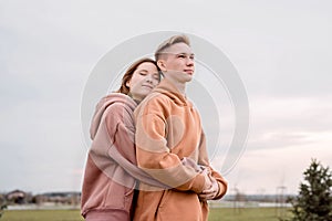 Young loving couple embracing each other outdoors in the park