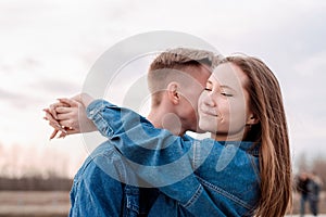 Young loving couple embracing each other outdoors in the park