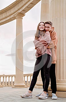 Young loving couple embracing each other outdoors in the park