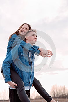 Young loving couple embracing each other outdoors in the park