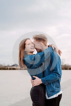 Young loving couple embracing each other outdoors in the park