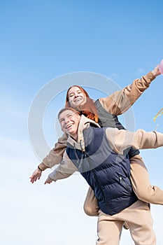 Young loving couple embracing each other outdoors in the park