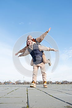 Young loving couple embracing each other outdoors in the park