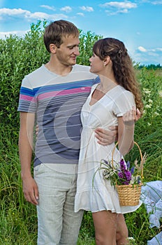 Young loving couple embracing in the field