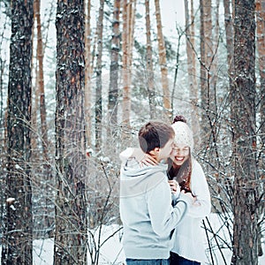 Young loving couple embracing and having fun in winter
