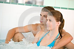 Young loving couple enjoy whirlpool bath photo