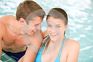 Young loving couple have fun in swimming pool