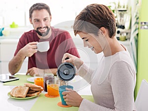 Young loving couple having breakfast at home