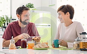 Young loving couple having breakfast at home