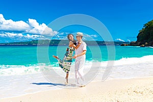 Young loving couple having fun in the tropical beach