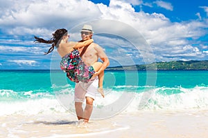 Young loving couple having fun in the tropical beach