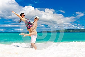 Young loving couple having fun in the tropical beach
